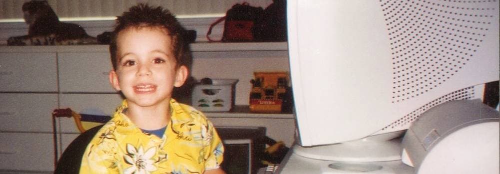 Drew as a child at the computer.